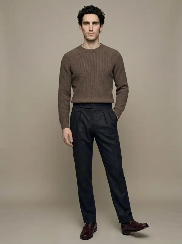 charcoal flannel double-pleat side-tab trousers worn by an AI male model, studio shoot