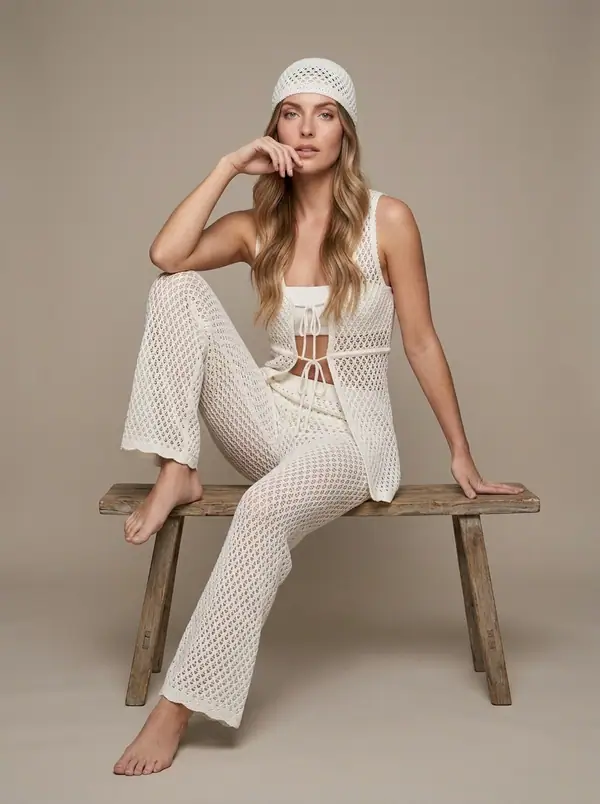 white crochet halter vest + wide crochet pants worn by an AI model, studio shoot
