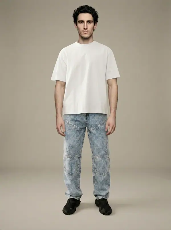 white heavyweight boxy tee + acid carpenter jeans worn by an AI male model, studio shoot